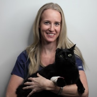 Animal Emergency Service Veterinarian, Dr Sara West with black cat